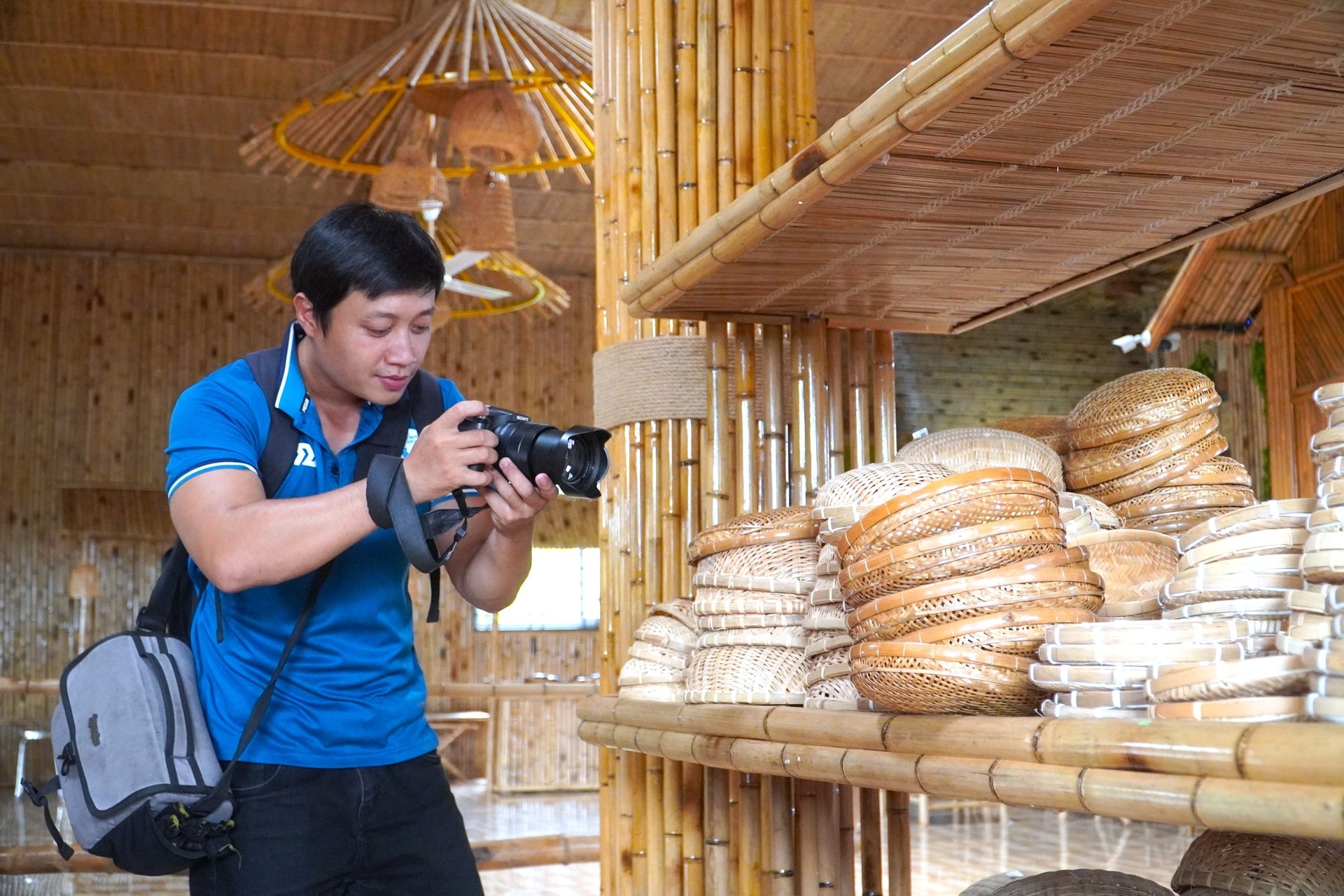 Visitors enjoy exploring and taking photos at the display and experience space of Thuy Tuyet Bamboo and Rattan Handicraft Cooperative. Photo: Kim Anh.