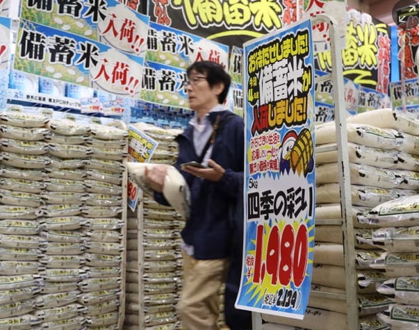 A customer walks past sacks of rice, released by the government from its reserve under a discretionary contract, at a branch of Japanese discount retailer Don Quijote. Photograph: JIJI PRESS/AFP/Getty Images. A customer walks past sacks of rice, released by the government from its reserve under a discretionary contract, at a branch of Japanese discount retailer Don Quijote. Photograph: JIJI PRESS/AFP/Getty Images.