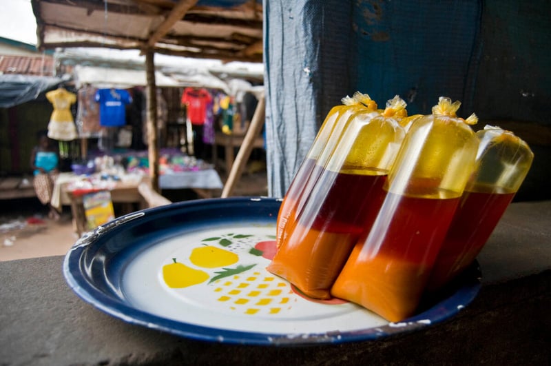 Palm oil for sale at a market in Moyamba, Sierra Leone. Photo: FAO/Caroline Thomas.